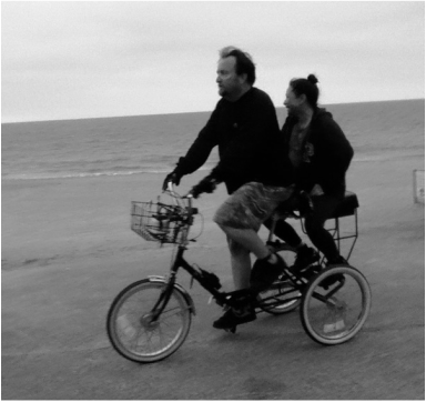 riding with companion bike seat on a tricycle on santa monica beach