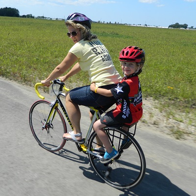 mother riding with child on bicycle with a companion bike seat