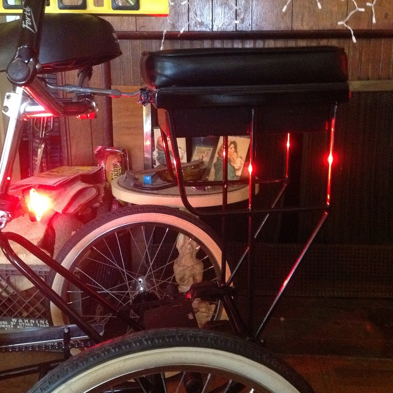 companion bike seat on a tricycle glowing red
