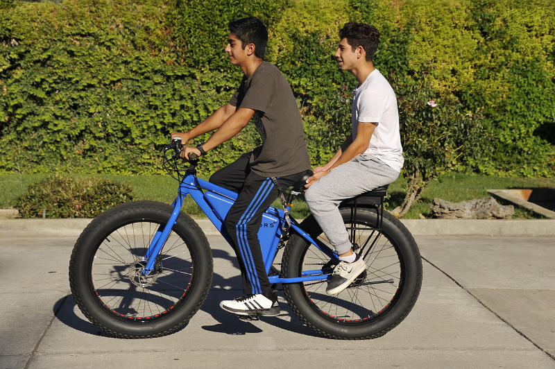 kids riding on a Sondors ebike with a Companion Bike Seat