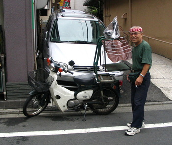 Japanese delivery scooter and owner